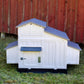 The large white Formex chicken coop is thoughtfully designed with easy-to-reach areas for egg collection and cleaning.