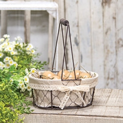 This Fabric Chicken Wire Basket is a decorative brown metal chicken-wire basket with a tall metal handle with a wooden grip.